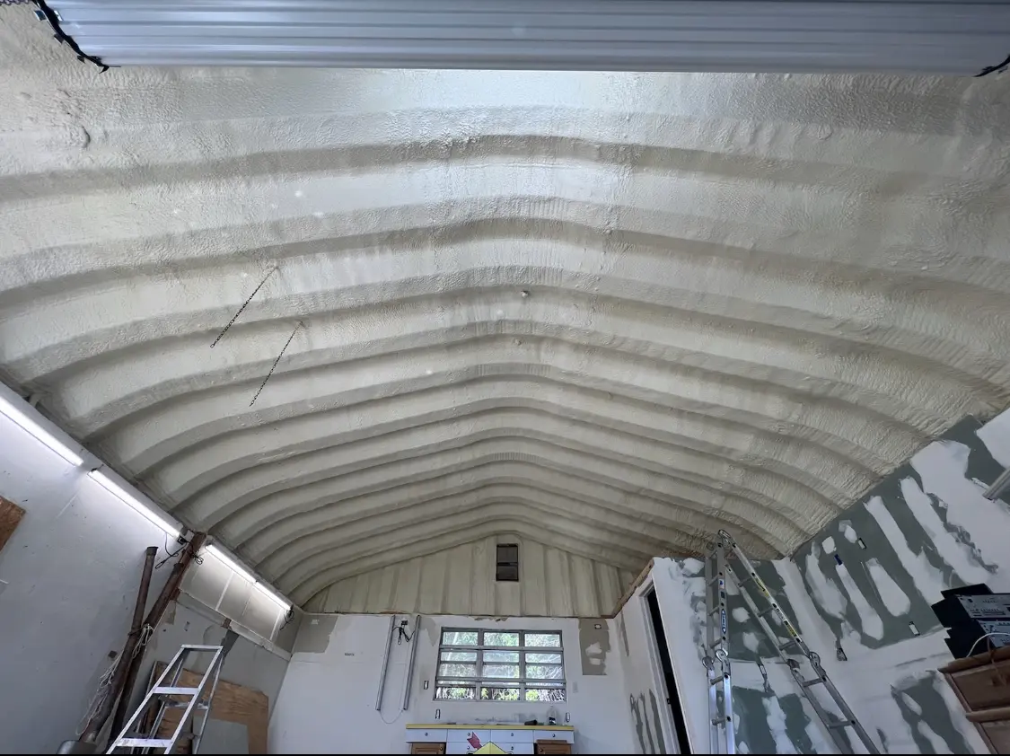 Spray polyurethane foam applied to the underside of a metal roof deck in North Dansville